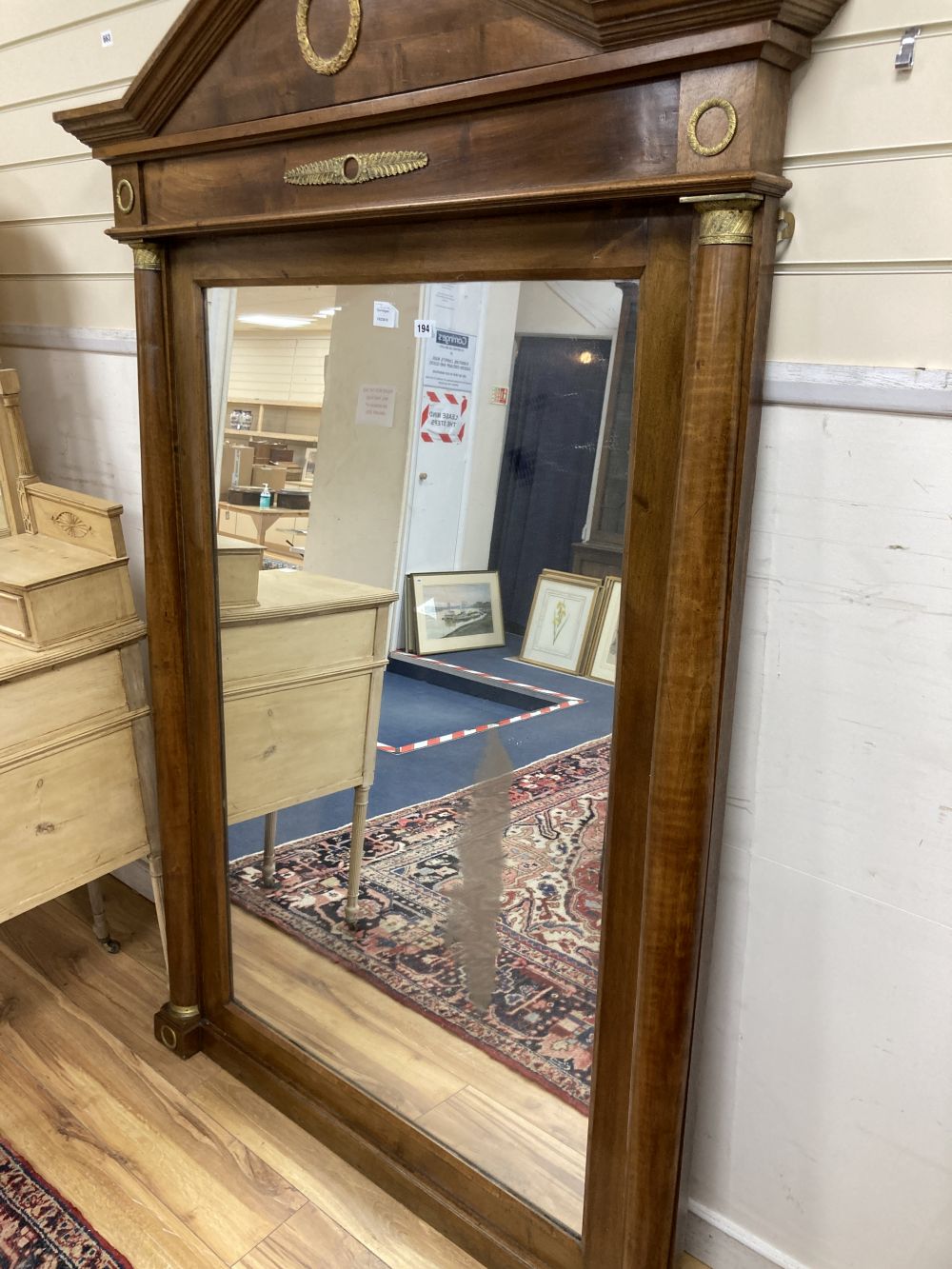 An Empire style mahogany gilt metal mounted overmantel mirror, width 125cm height 190cm